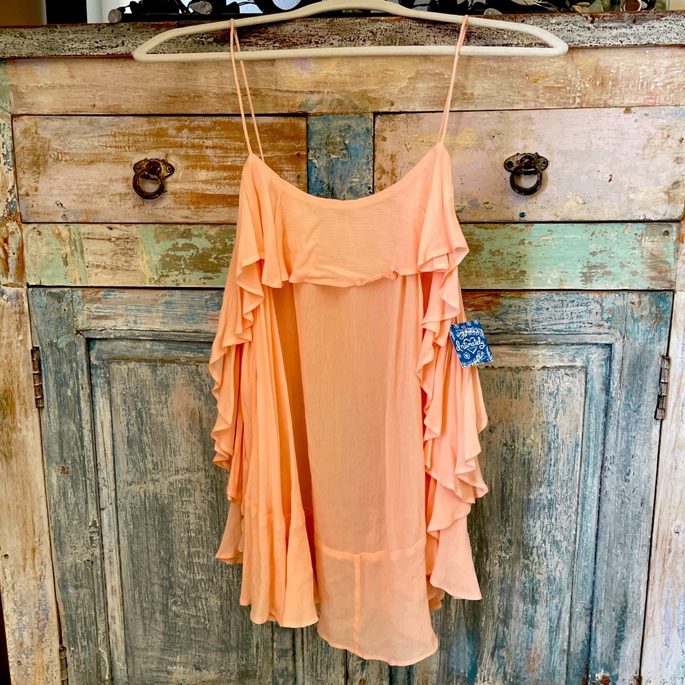 Free People tank with tag yet tiny small hole.